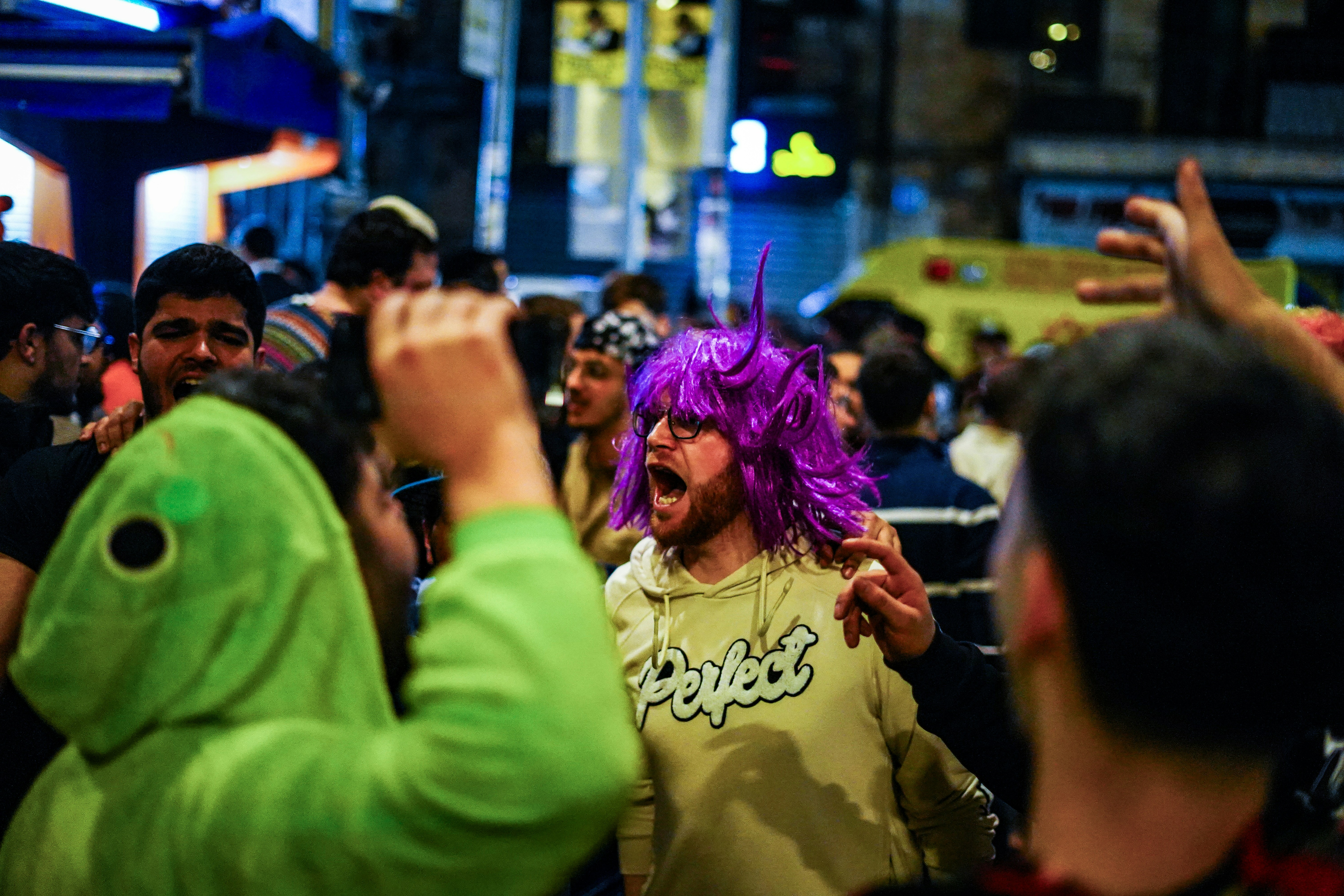 People are celebrating in the crowded street.