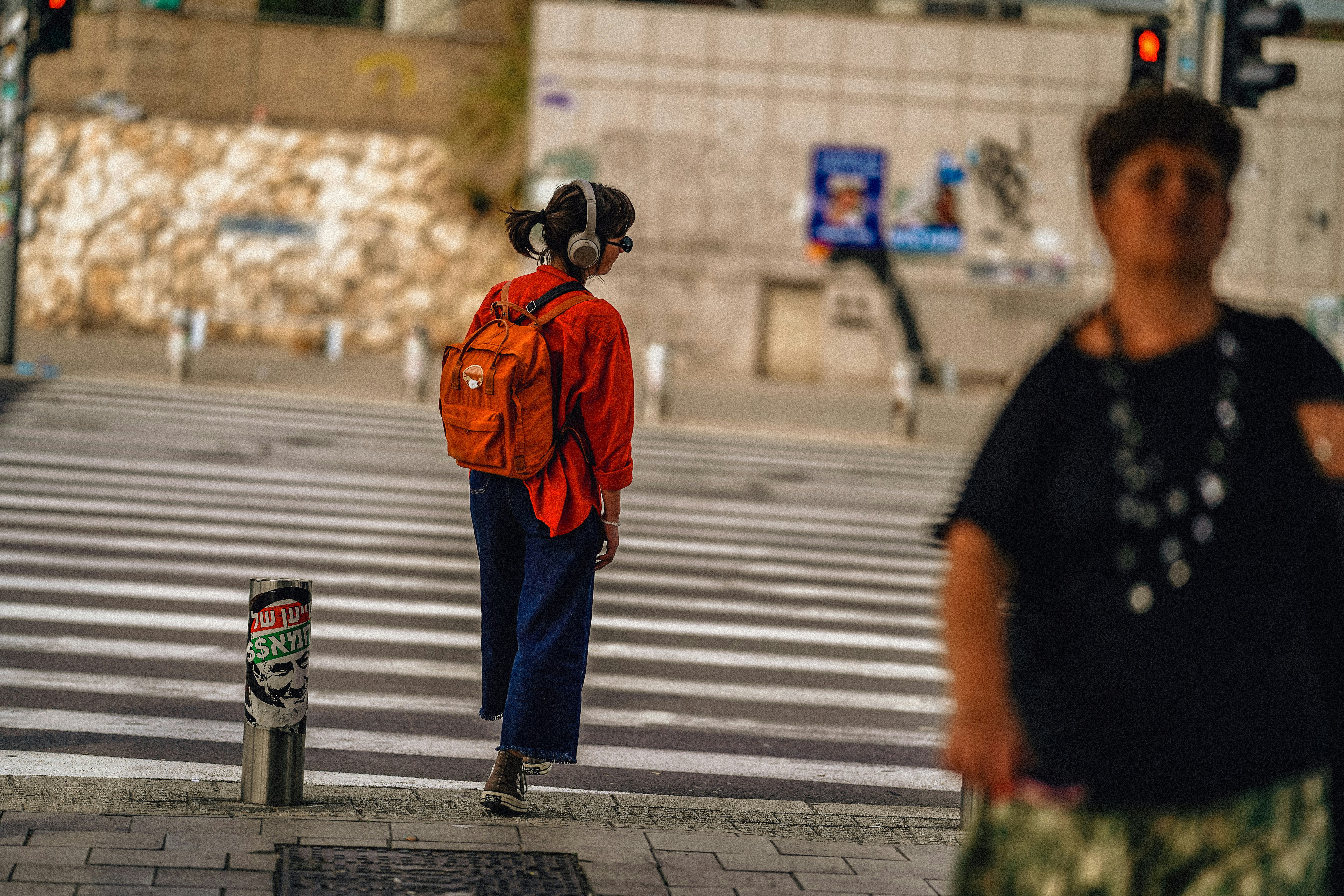 A person walks on a crosswalk in the city.