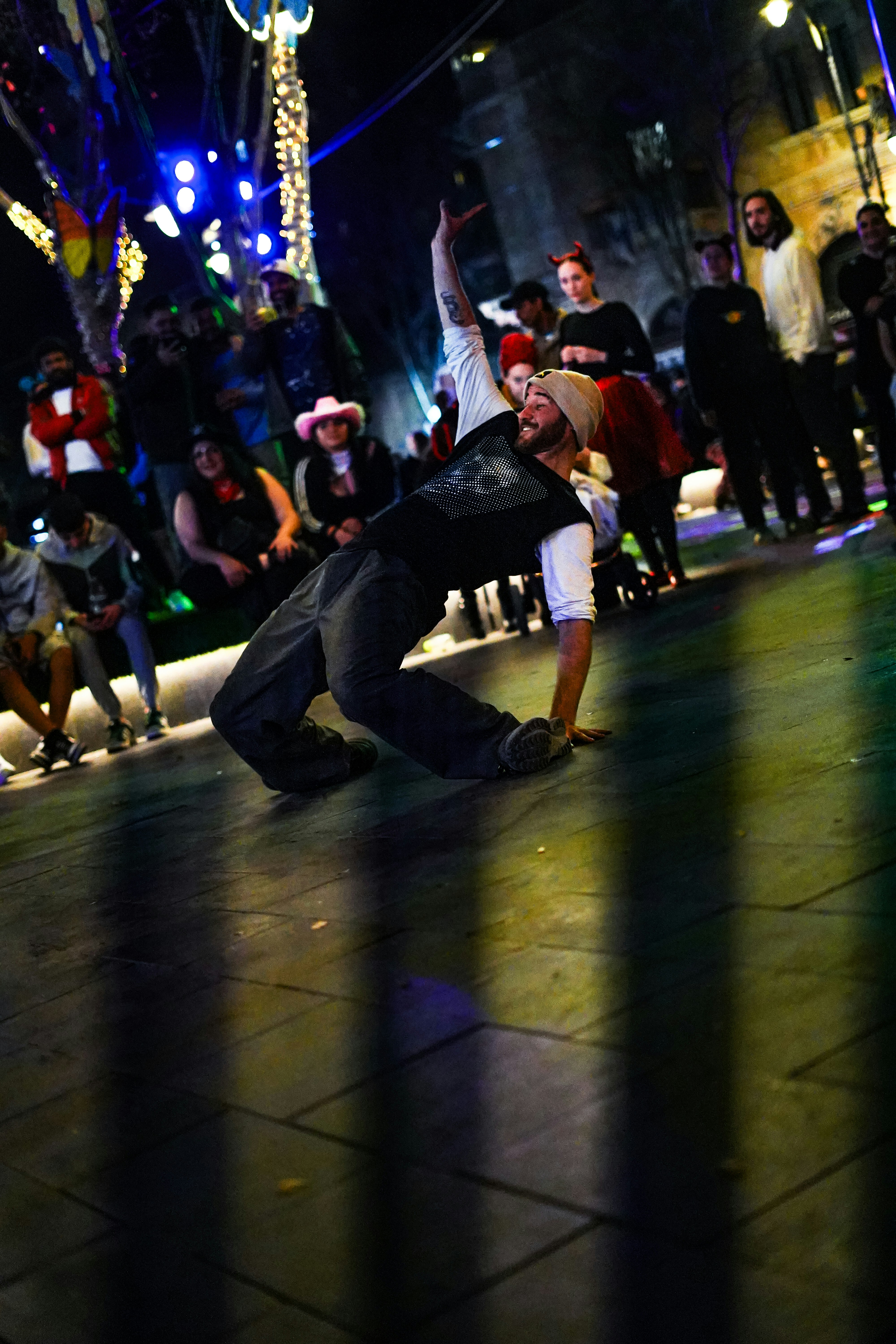 A breakdancer performs in front of a crowd.