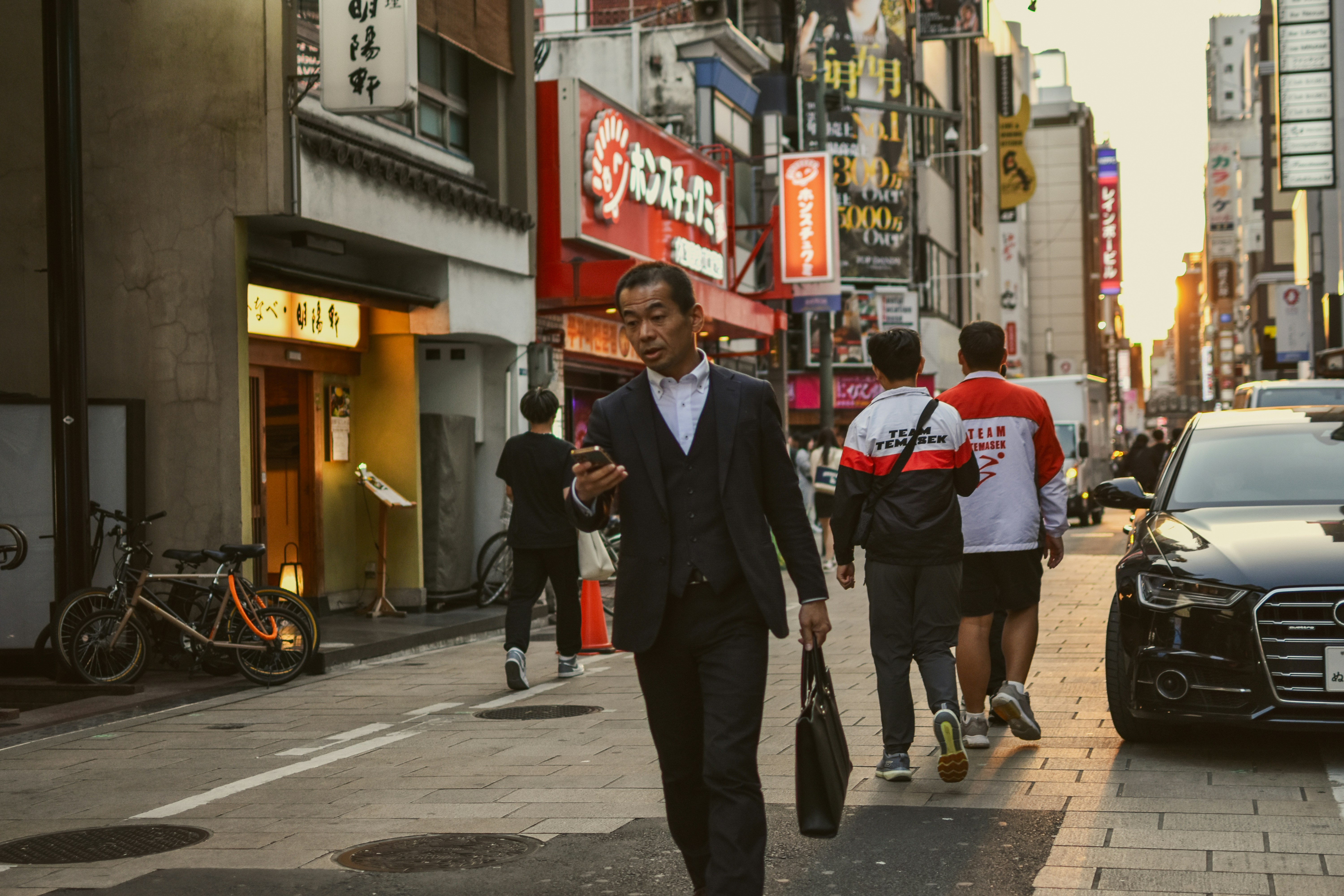 A businessman walks down a busy city street.