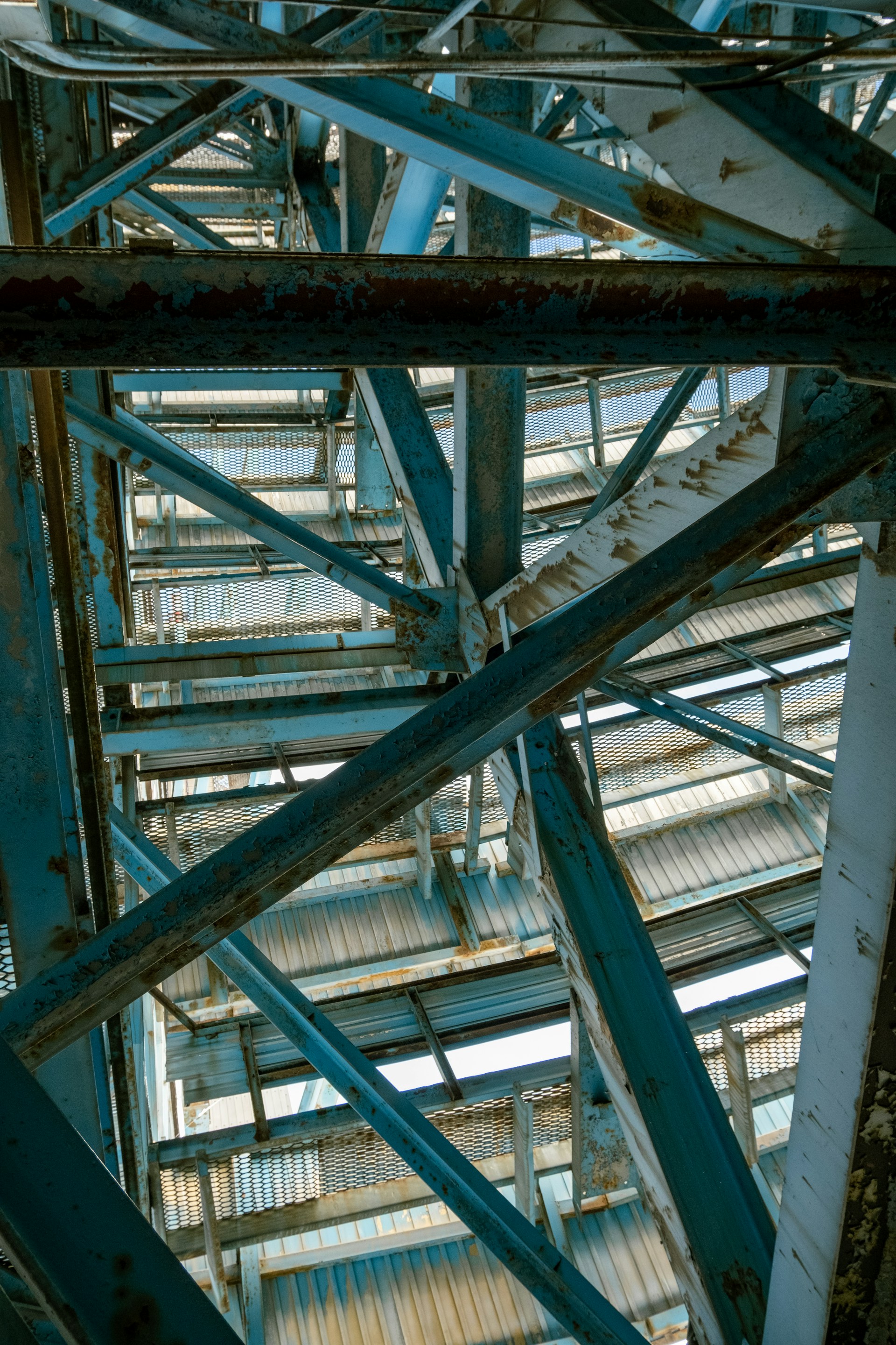 Blue metal beams create an intricate geometric structure.