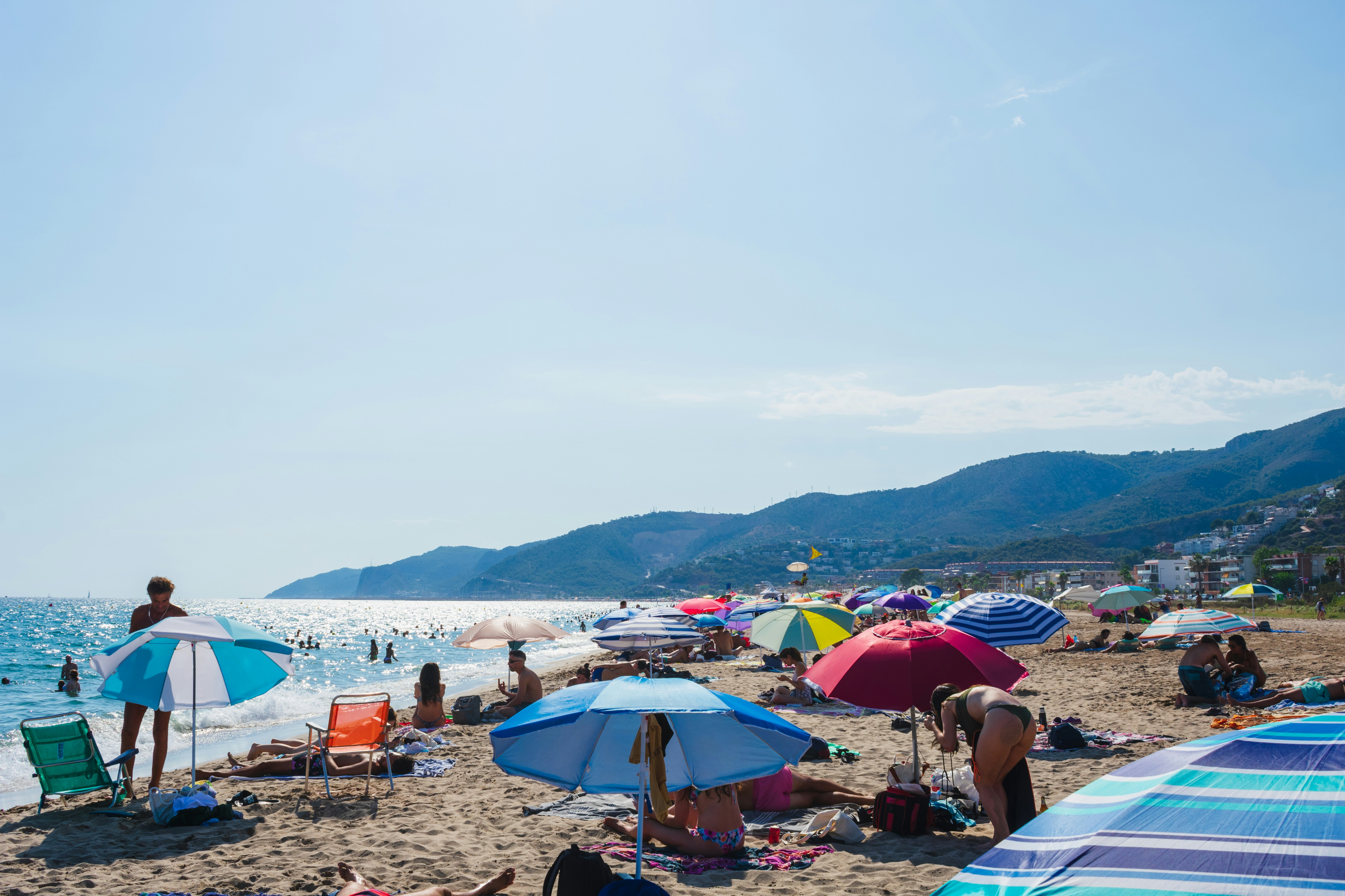 People enjoy a sunny day on the beach.