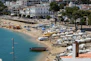 Beachfront with boats and a beautiful coastal town.