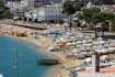 Beachfront with boats and a beautiful coastal town.