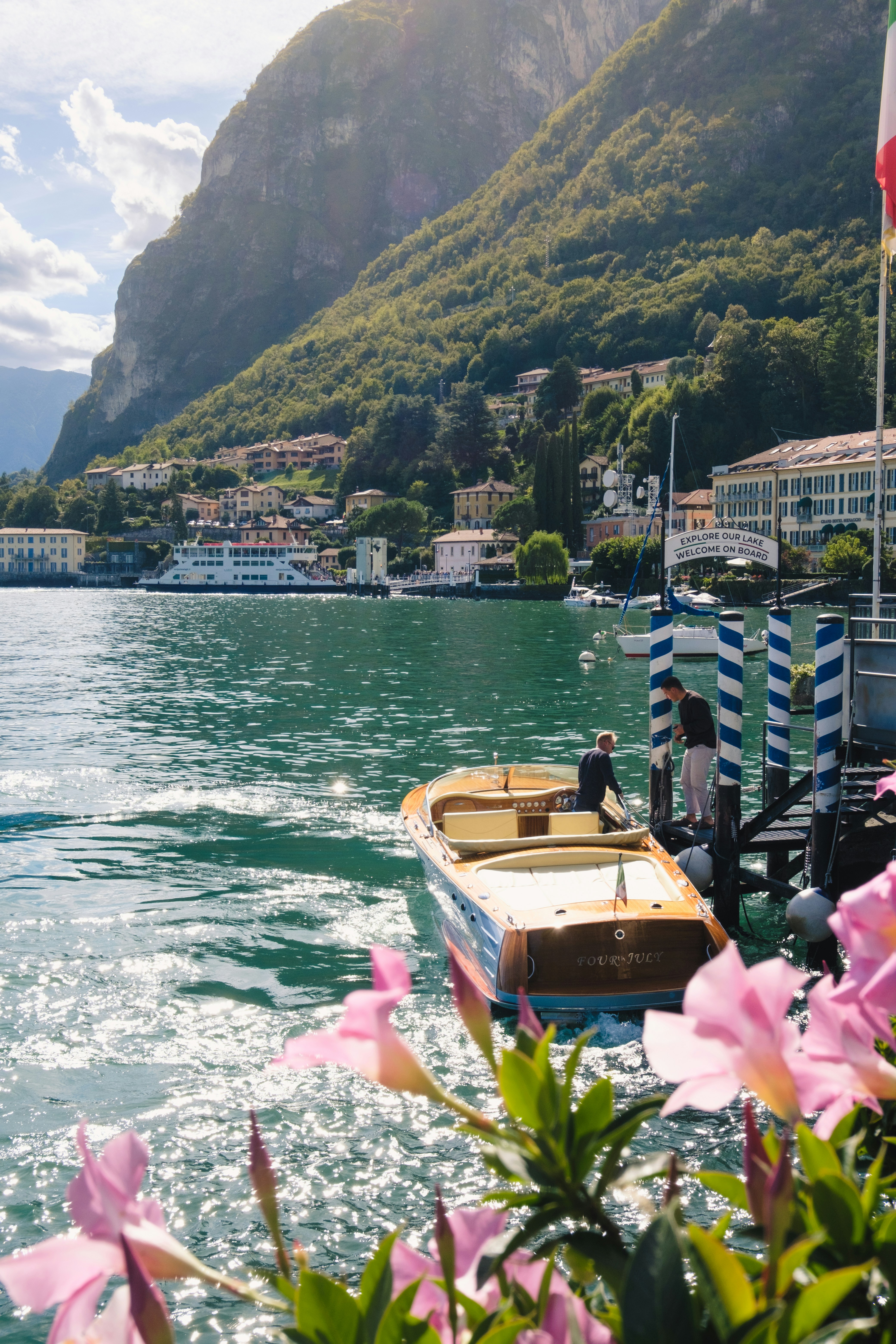 A boat docks at a beautiful lakeside town.
