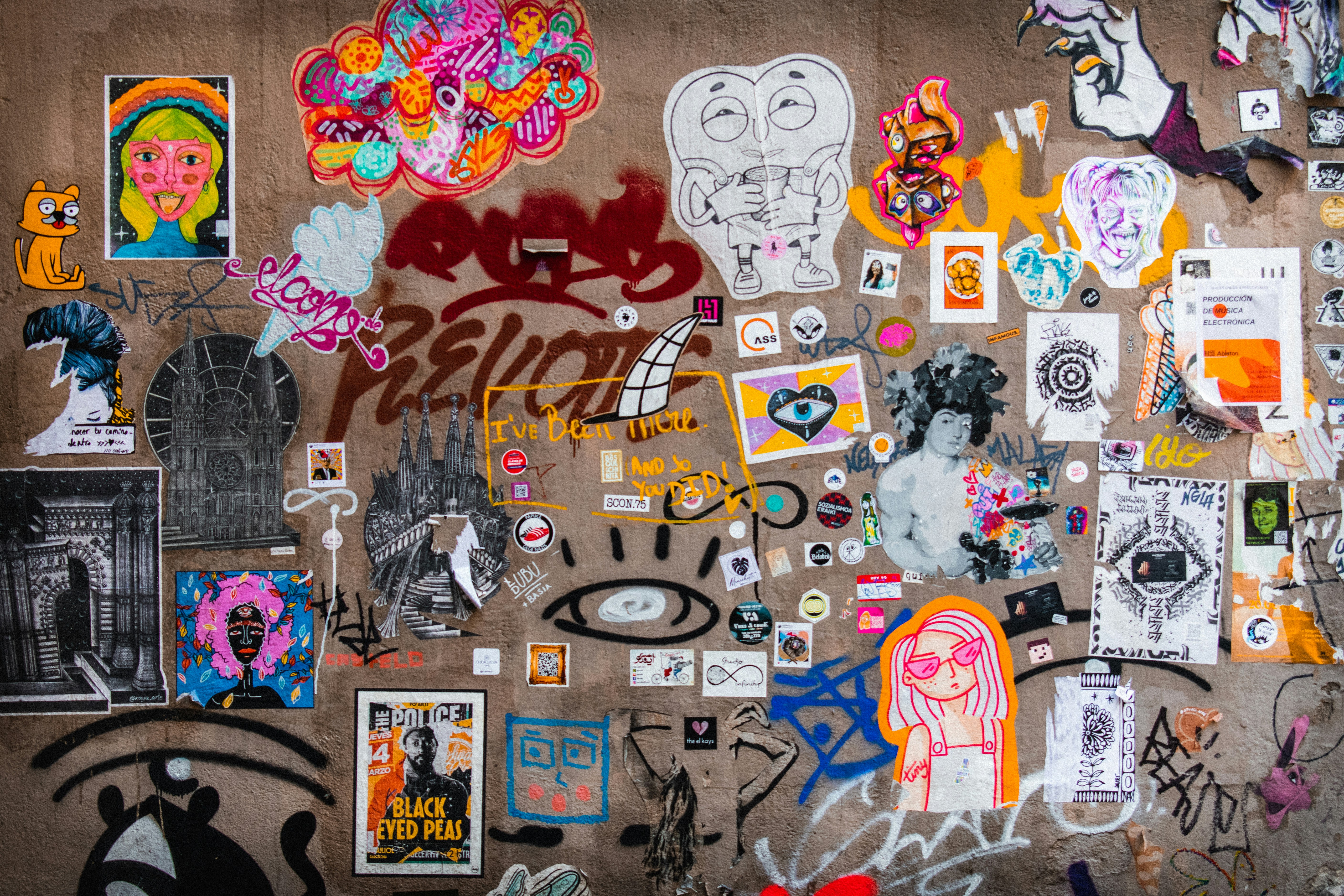 The wall is covered in various colorful stickers.