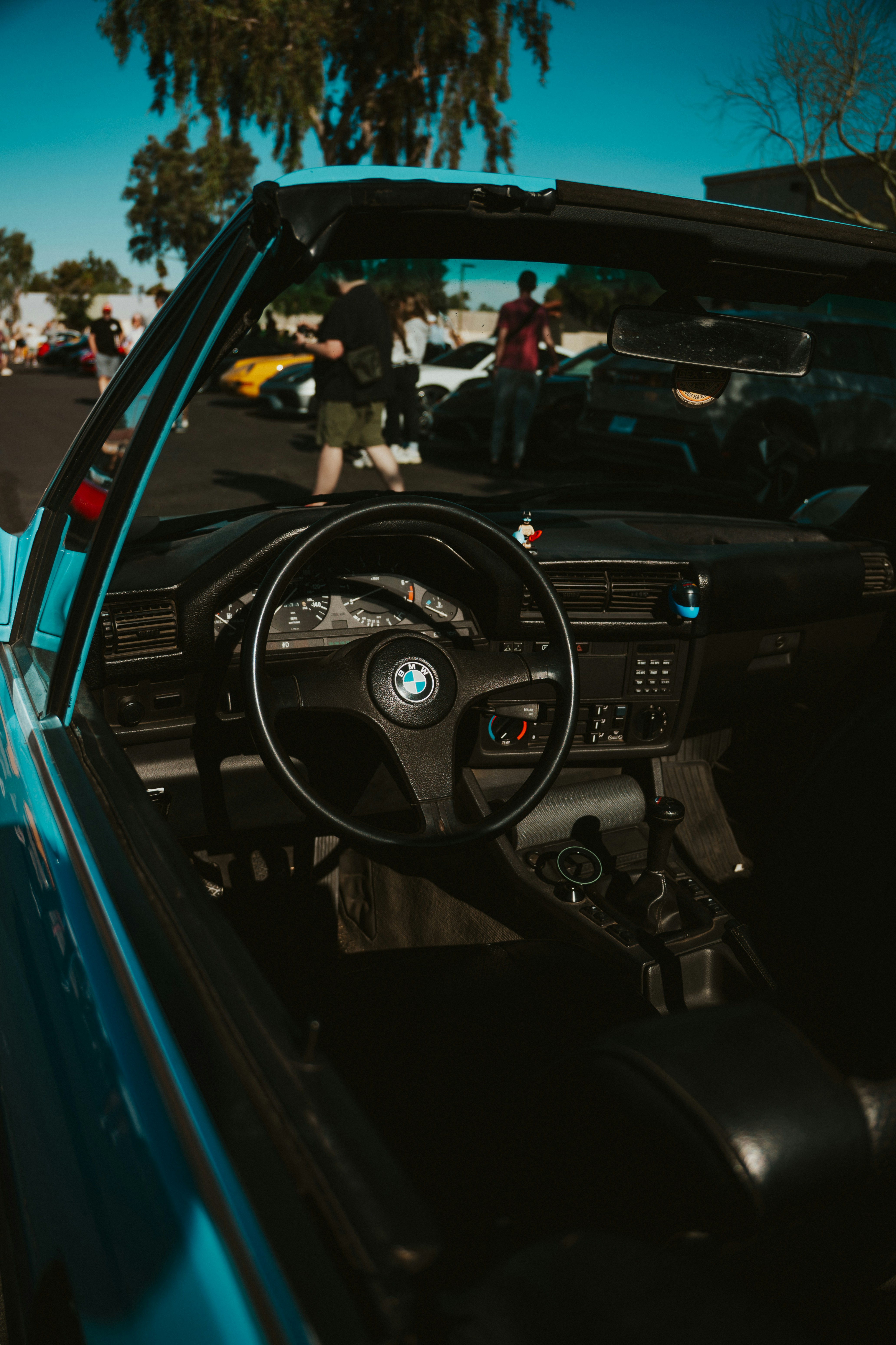 Here's a caption: inside of a classic BMW convertible.