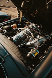 A classic car engine with its hood open.