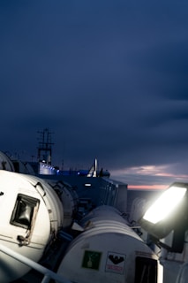 A ship at dusk sailing into the distance.