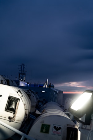 A ship at dusk sailing into the distance.