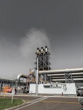 Industrial smokestacks releasing steam into the sky.