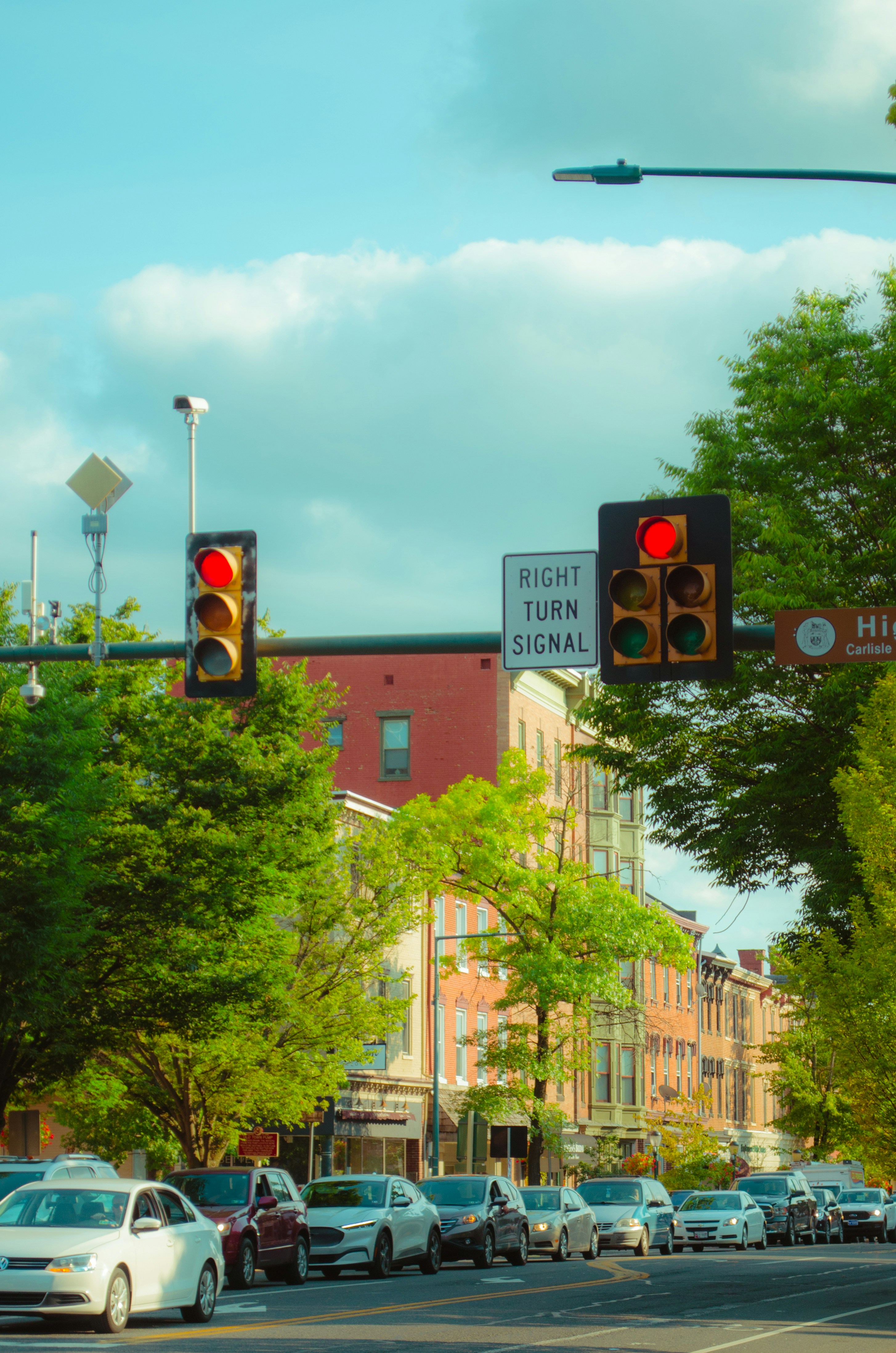 Red traffic lights restrict busy city traffic.