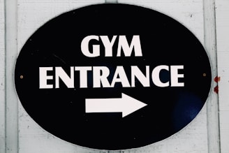The sign points to the gym entrance.