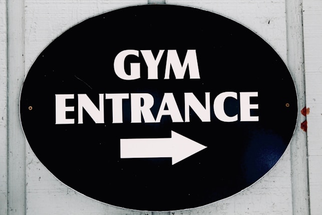 The sign points to the gym entrance.