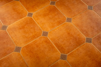 Diamond-patterned tiles cover a brown surface.