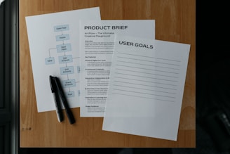 Documents and a pen lay on a wooden surface.