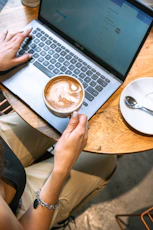 Working on a laptop with a coffee nearby.