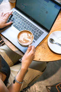 Working on a laptop with a coffee nearby.