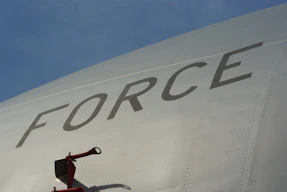 A plane's fuselage with "force" written on it.