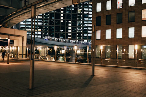 A cityscape at night, with bright buildings.