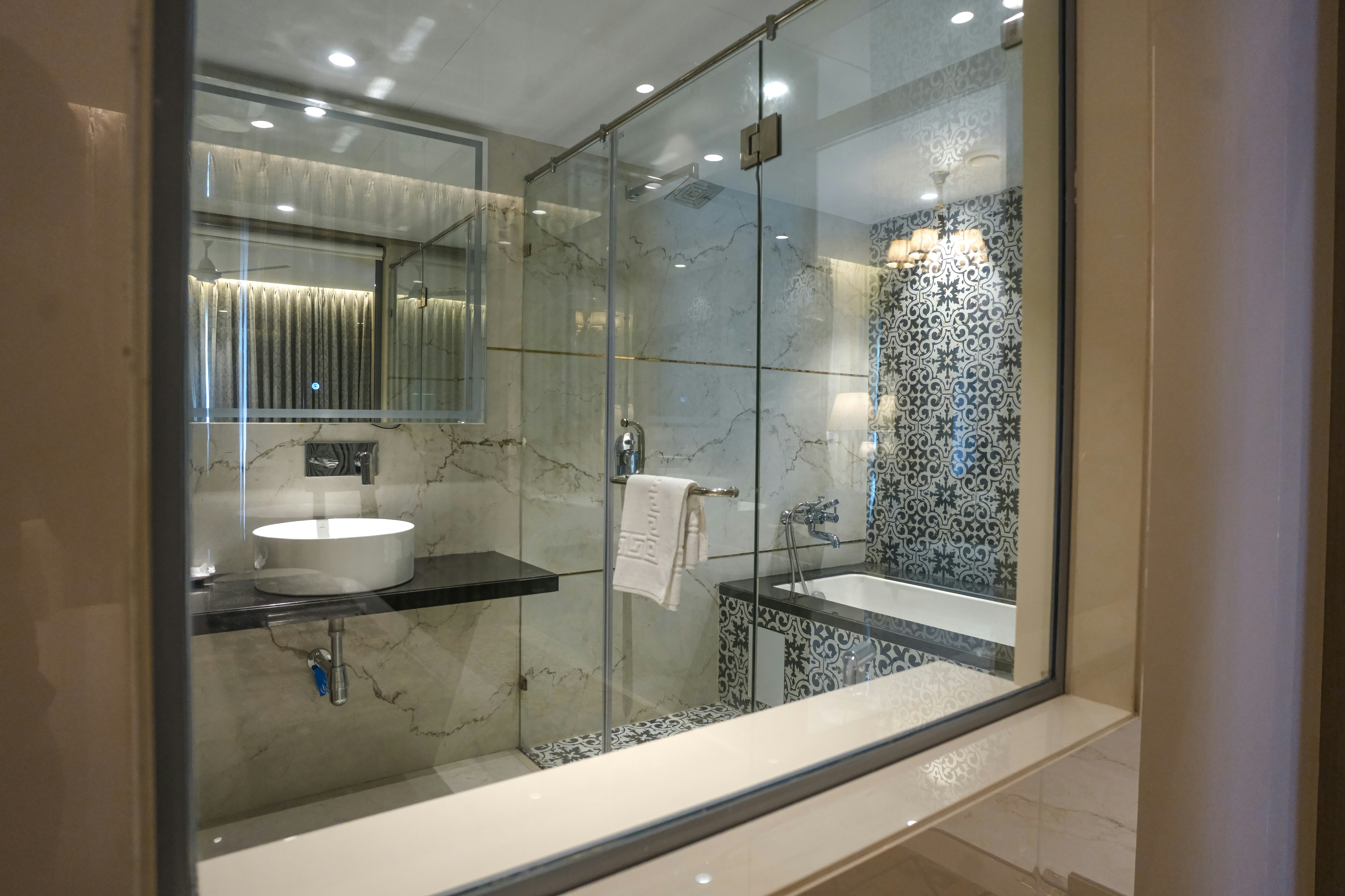 A modern bathroom features a shower and sink.