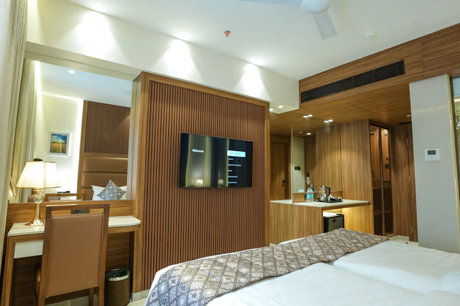 A luxurious and modern hotel room with a desk.