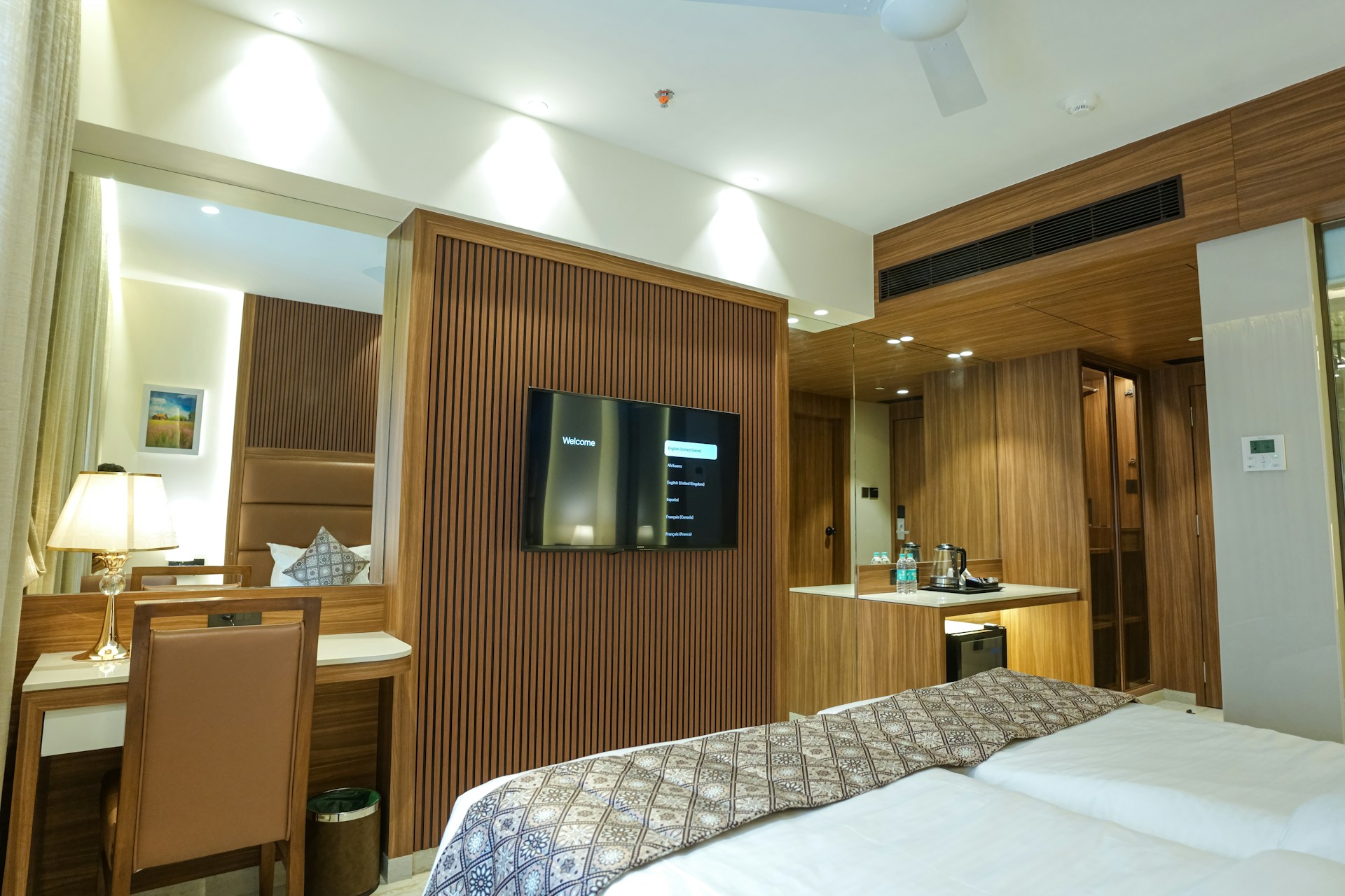 A luxurious and modern hotel room with a desk.
