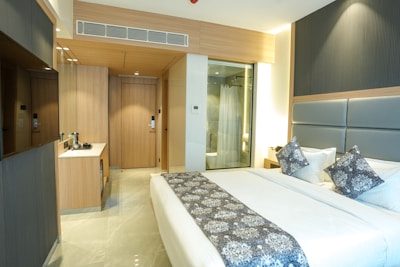 A modern hotel room with a bed and bathroom.