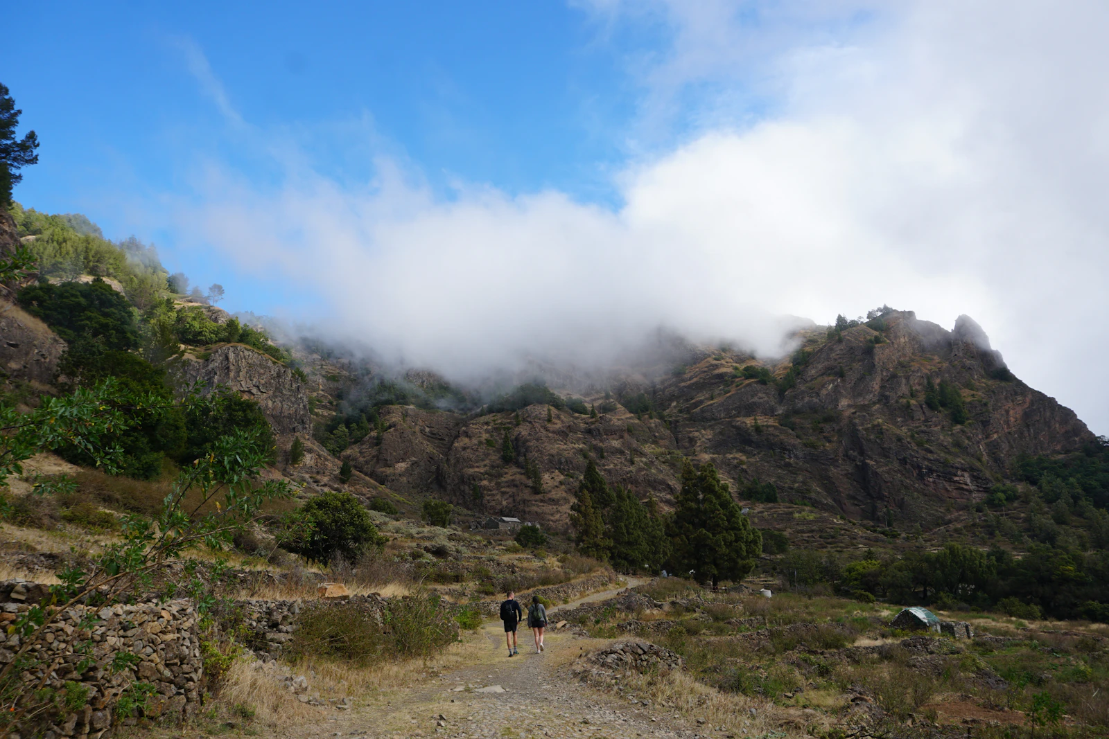 Hikers below the cloud rolling over the mountains — Santo Antão, Cape Verde