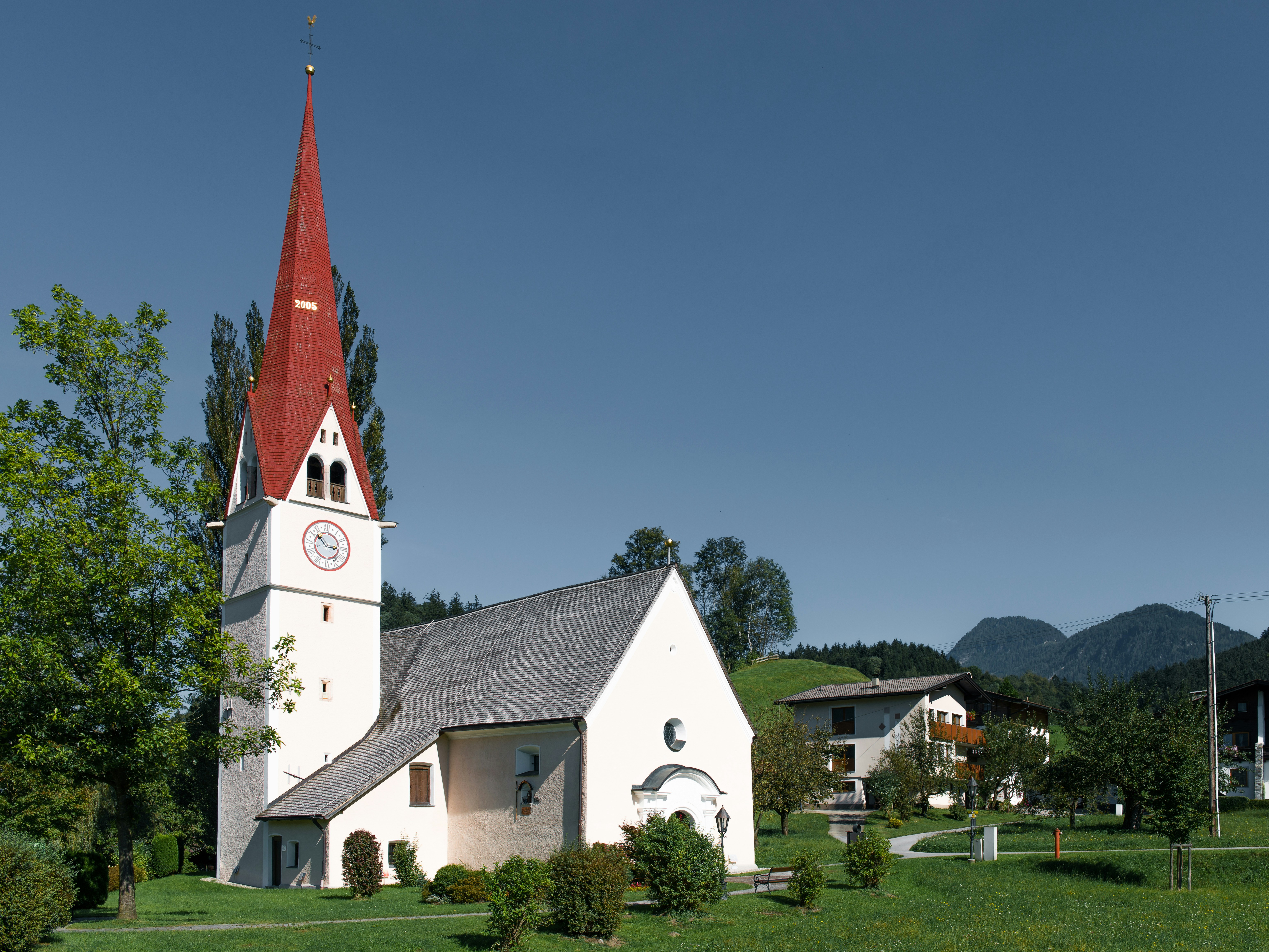A church with a red steeple stands tall.