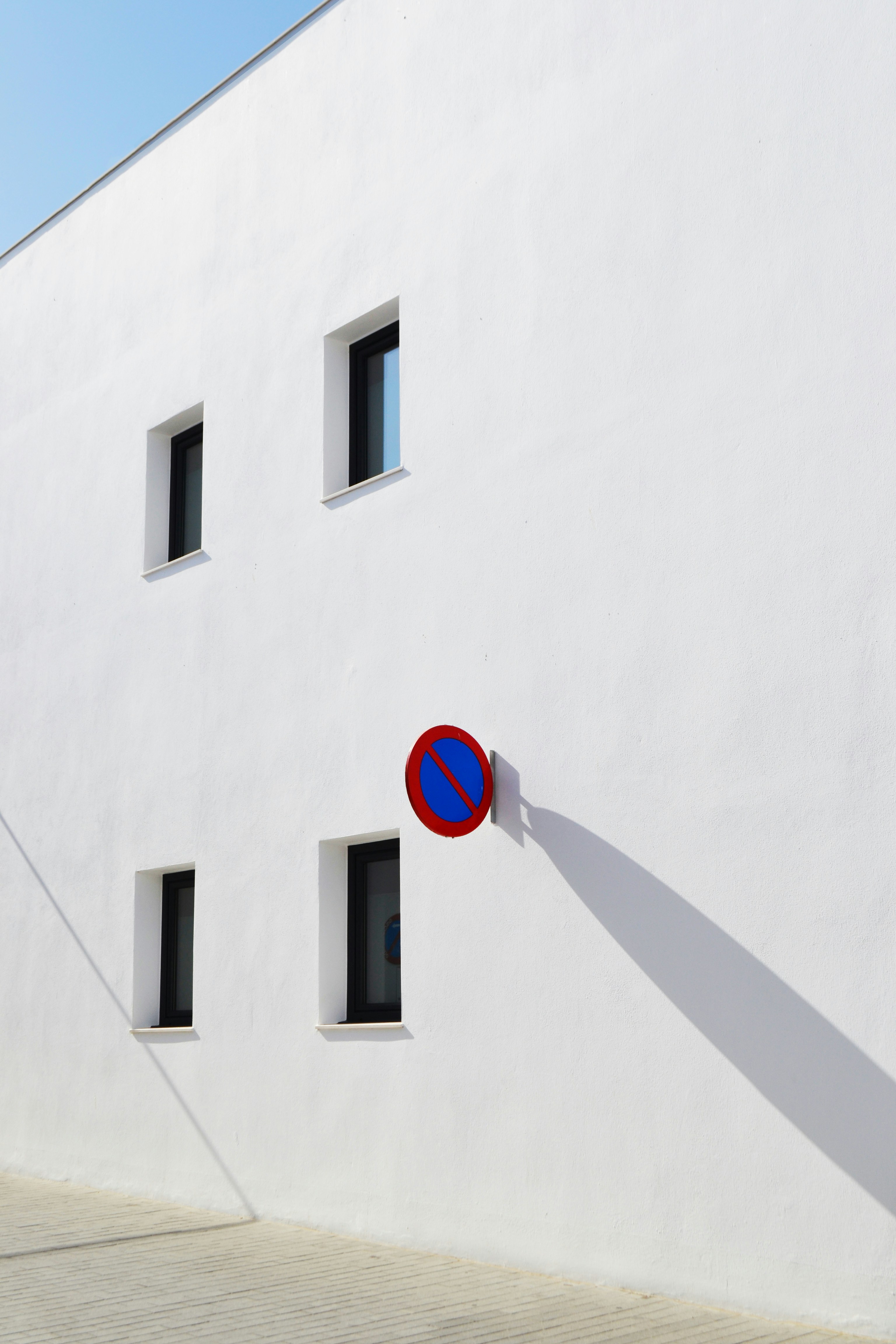 A white building with no parking sign.