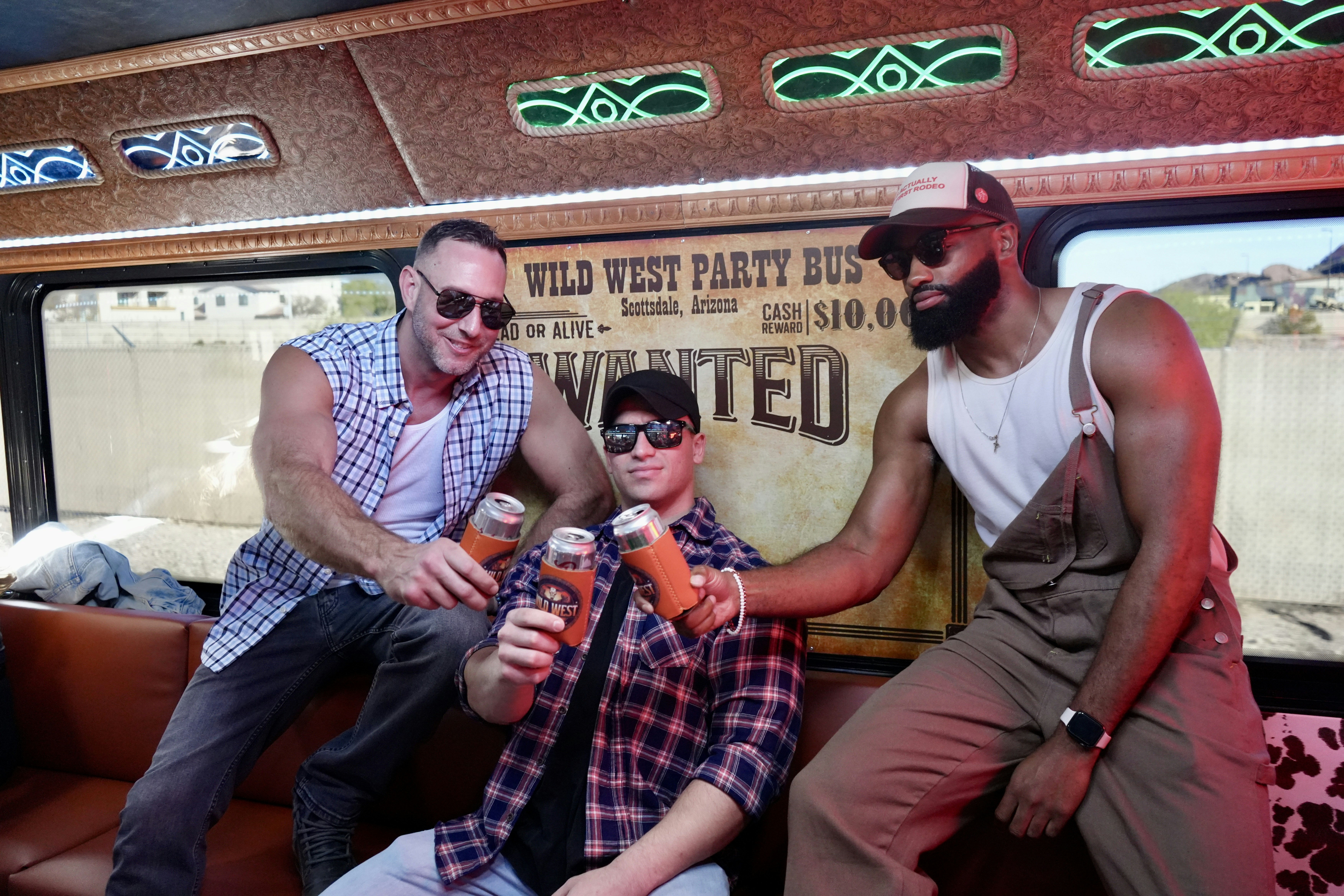 Men celebrate on a "wild west" themed party bus.