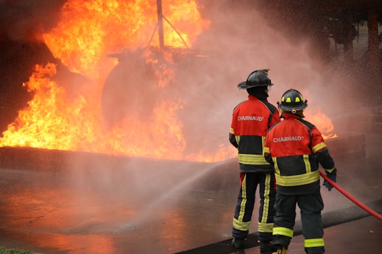 Firefighters battle a blaze with water.