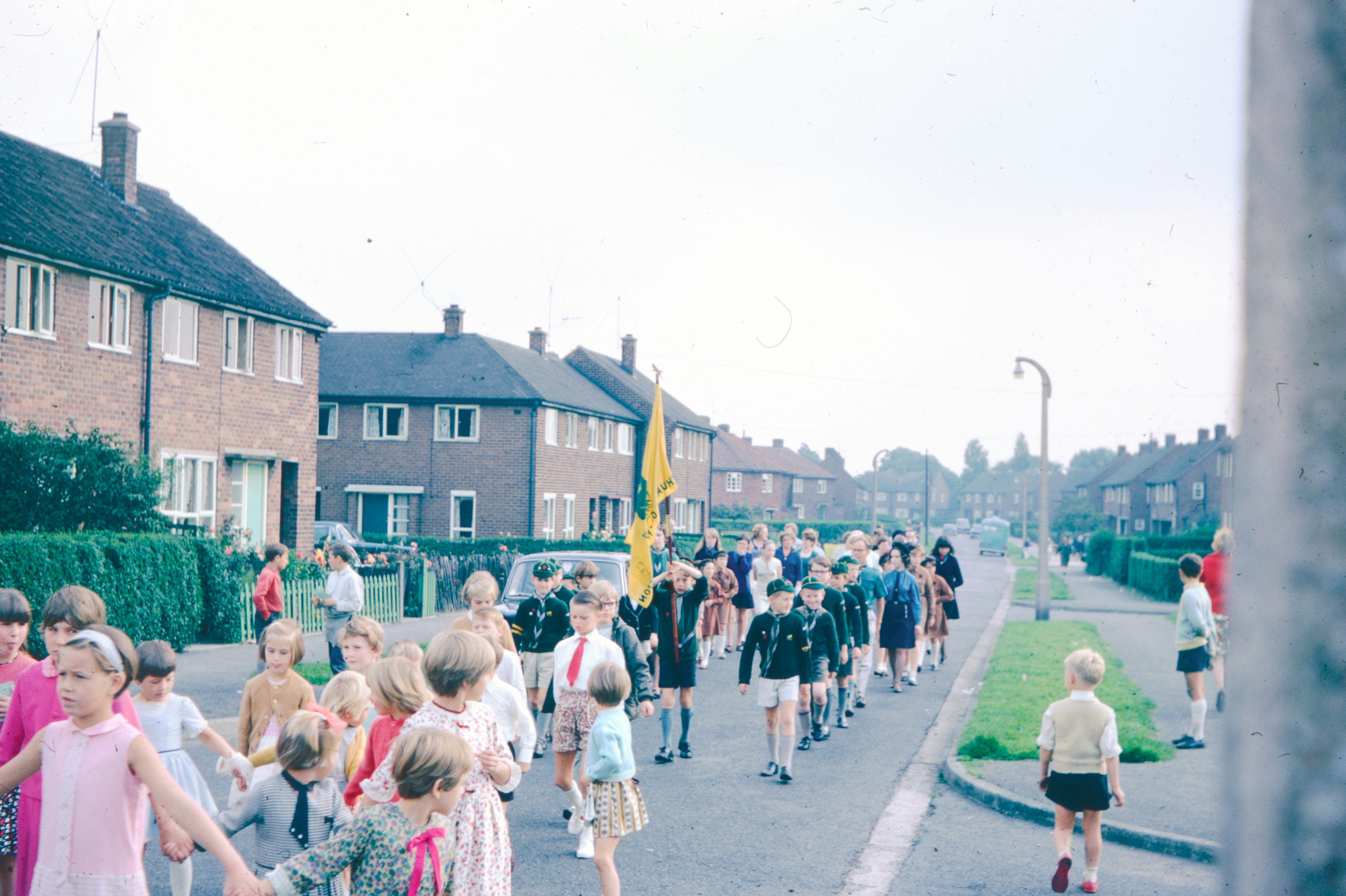 Children parade down a residential street.
