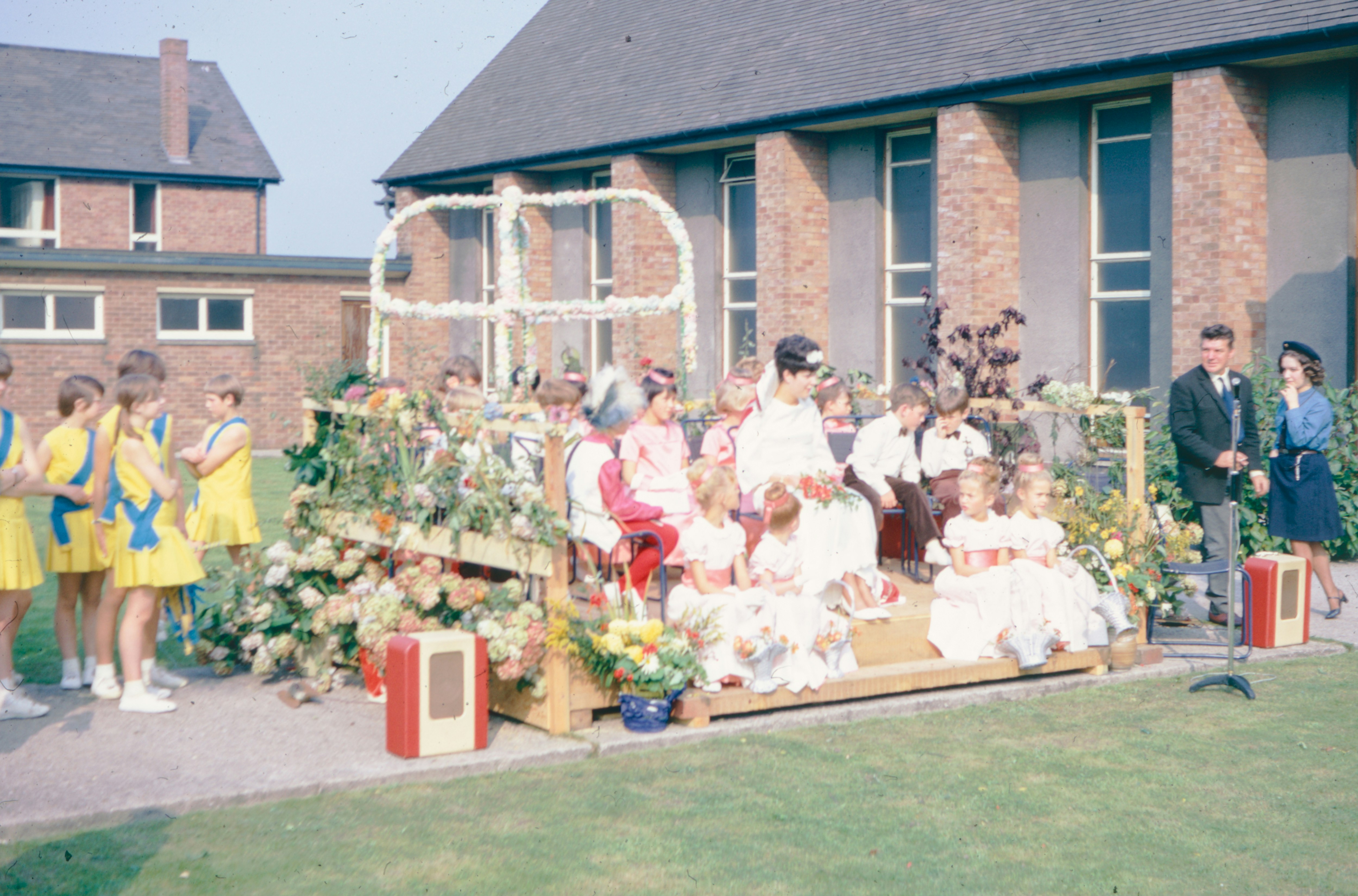 Children are seated on a decorated float.
