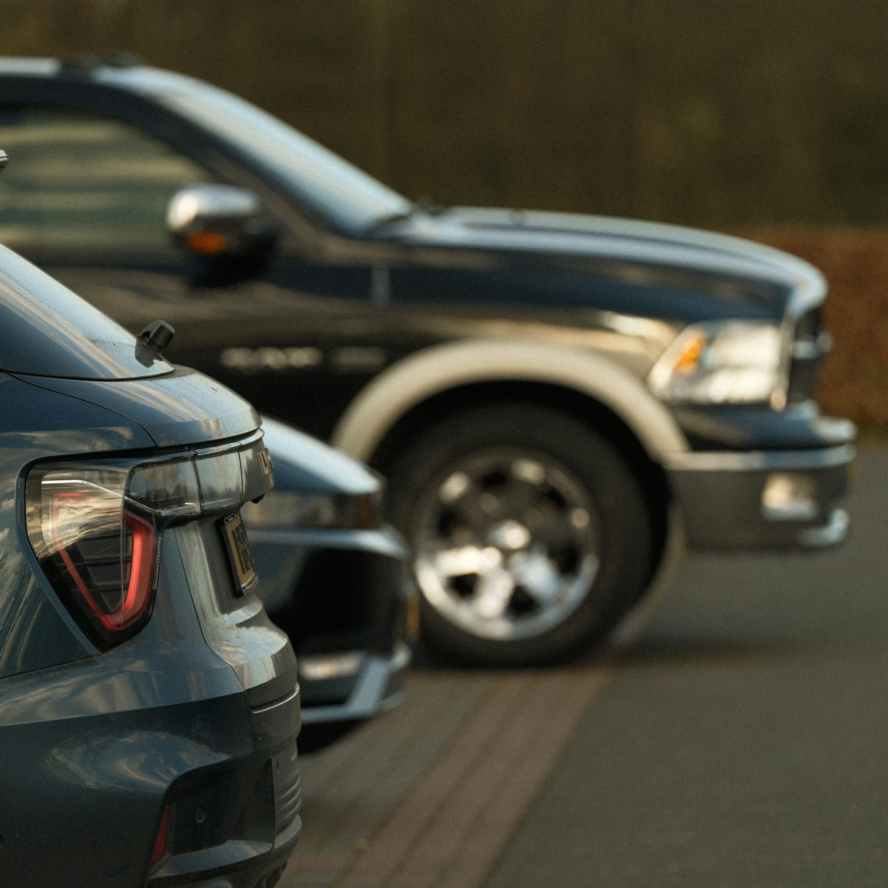 Cars are parked in a line, side-by-side.