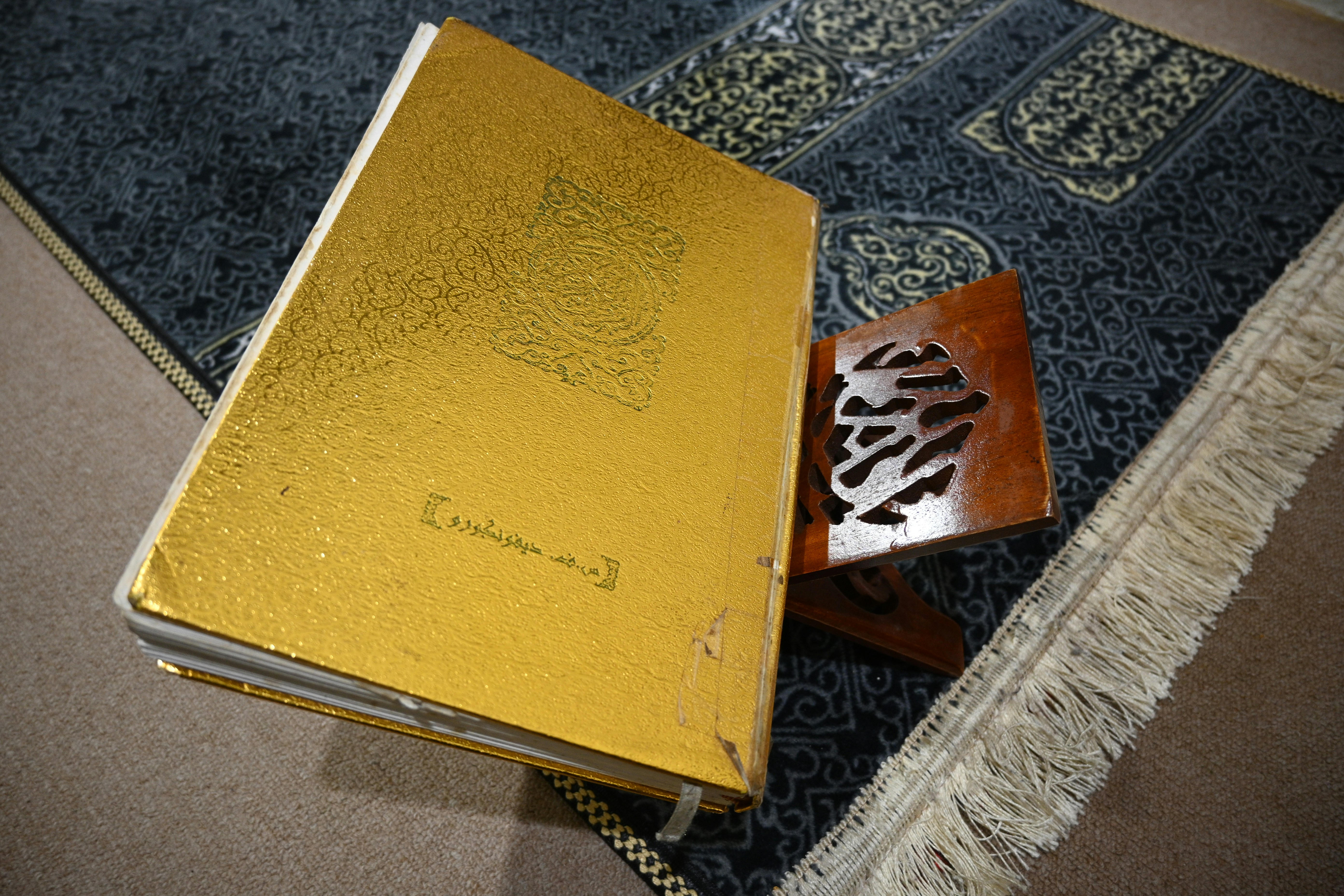 Golden book on wooden stand