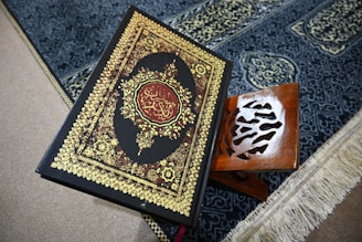 The quran rests on a prayer rug.