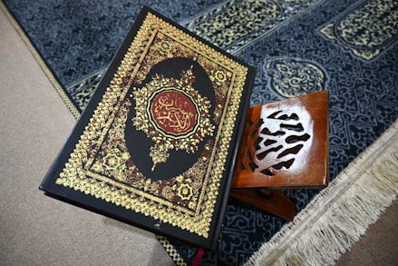 The quran rests on a prayer rug.
