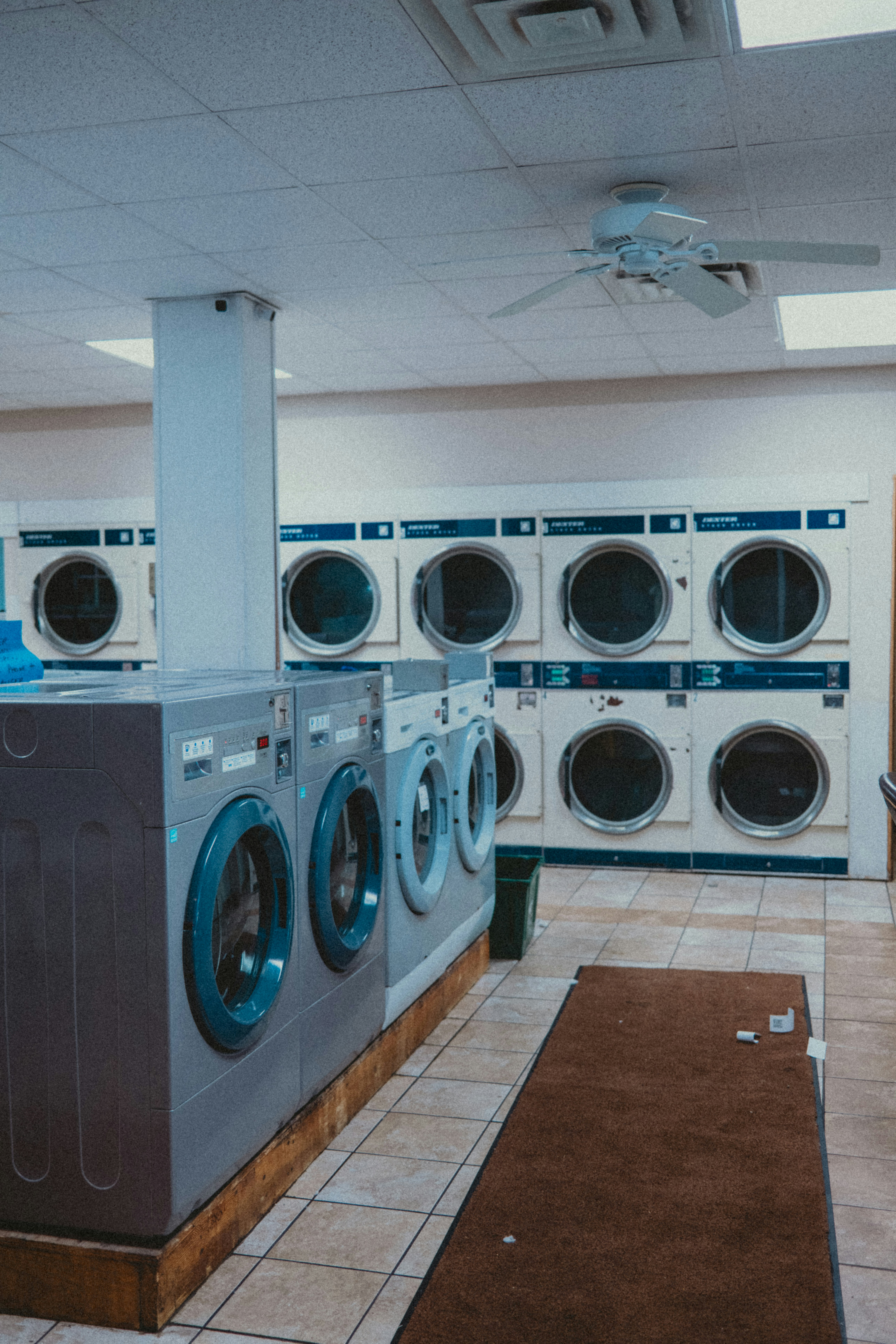 A laundromat with rows of washing machines.