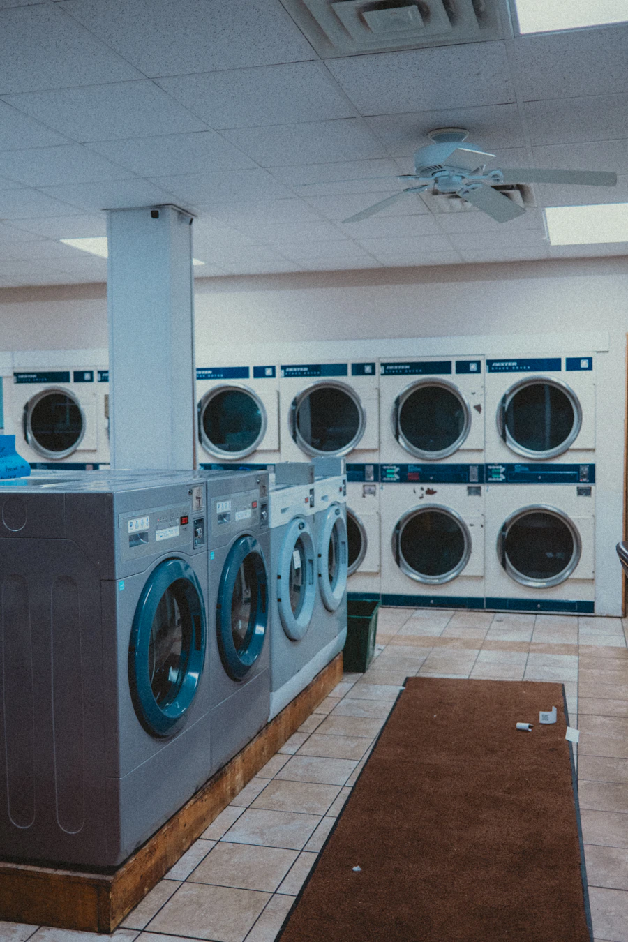Laundromat interior with rows of washers