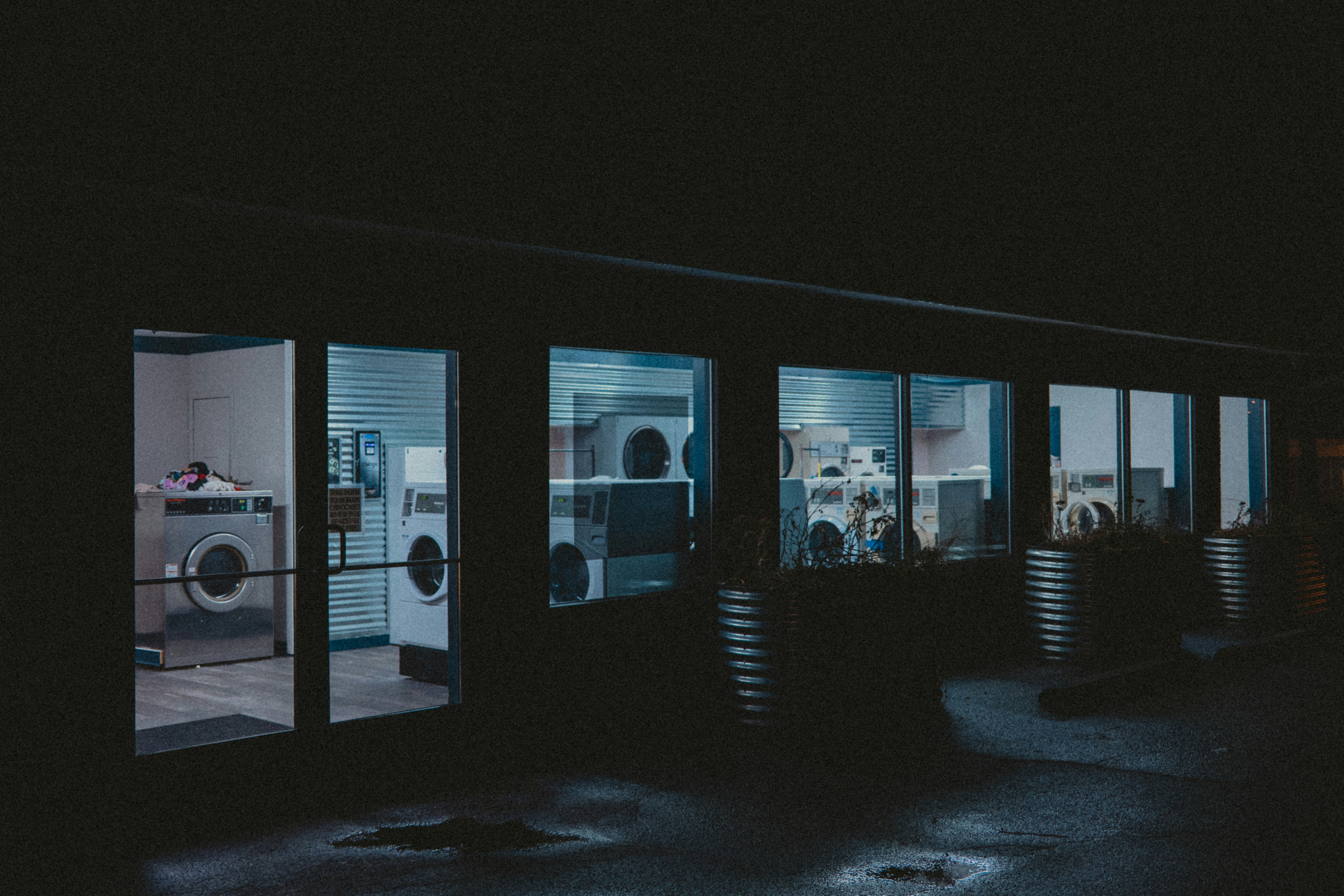 A laundromat sits empty at night.