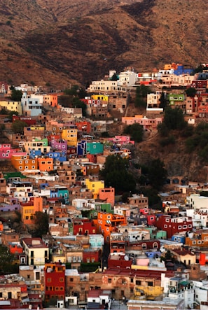 Colorful buildings cascade down a hillside.
