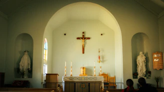 A church interior with a crucifix and religious statues.