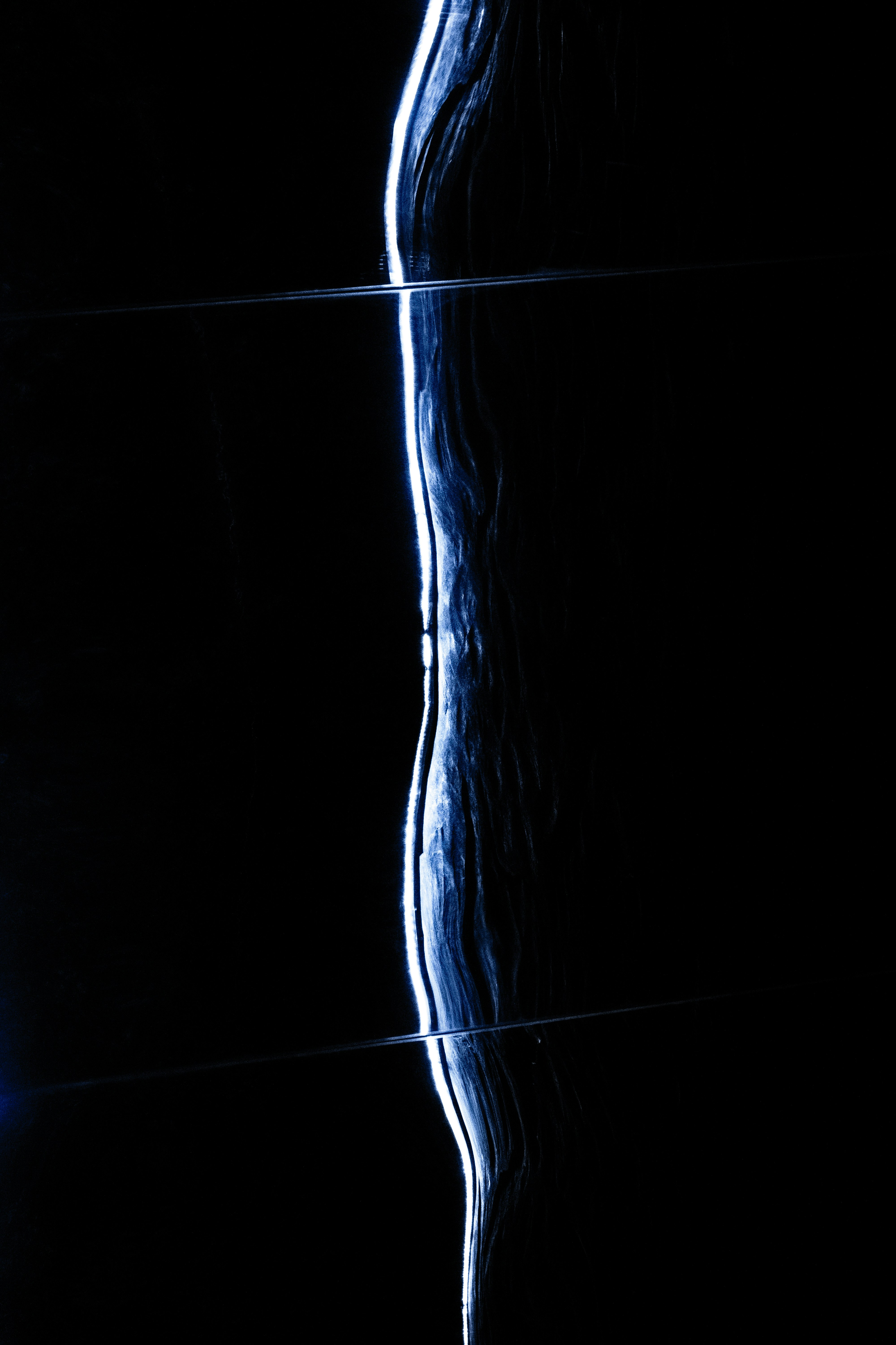 Flowing water against a dark background.