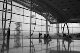 Inside an airport, looking out at a tower.