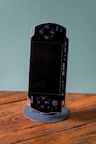 A black psp handheld console is on display