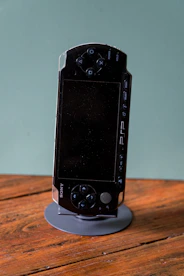 A black psp handheld console is on display