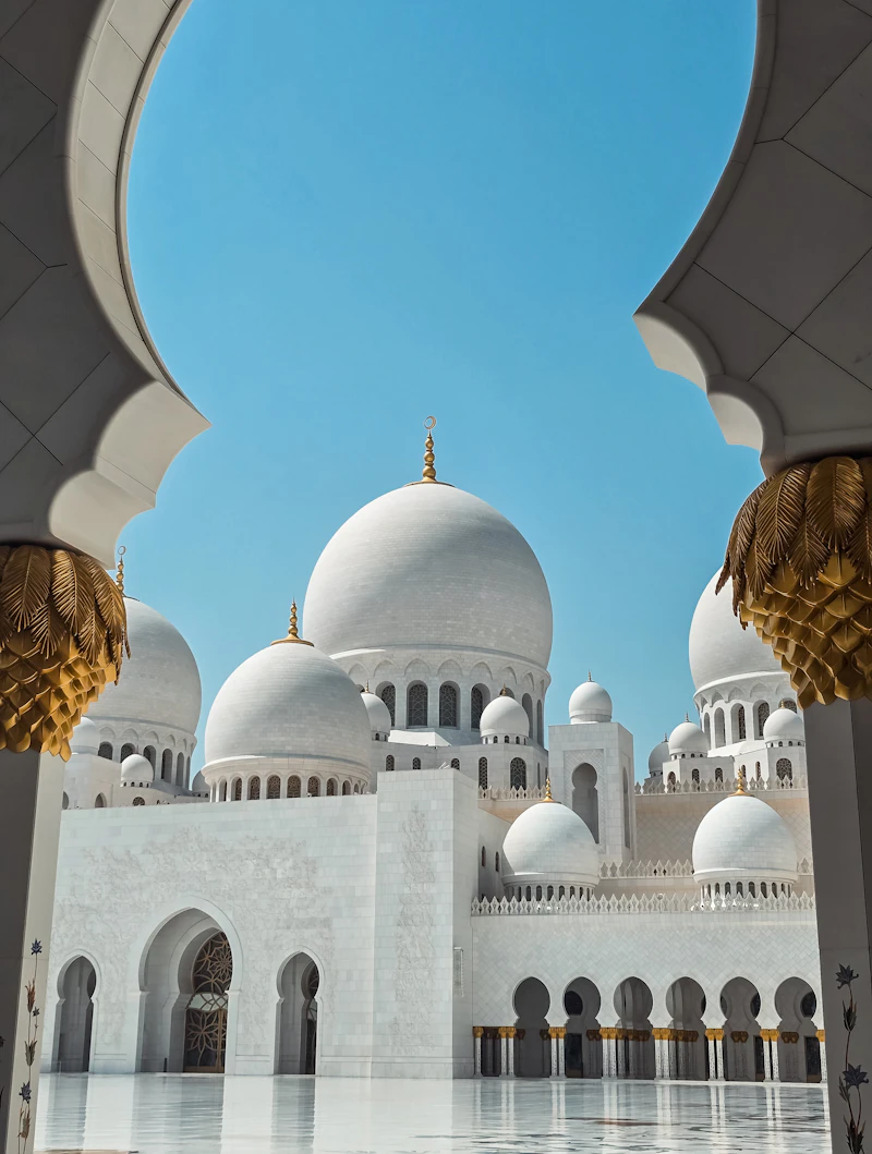 Domes of Sheikh Zayed Grand Mosque framed by an arch