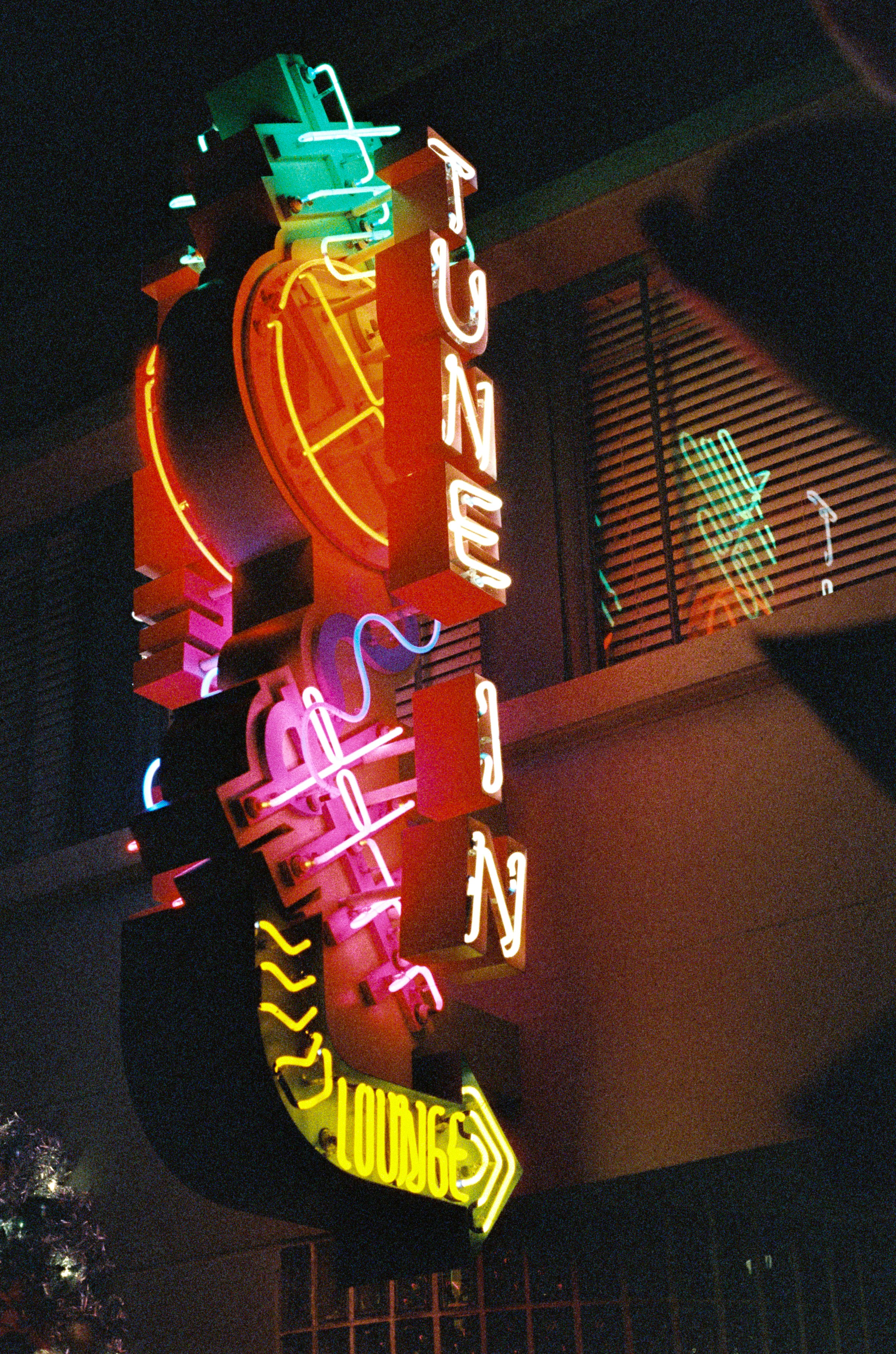 Neon sign of a lounge at night.